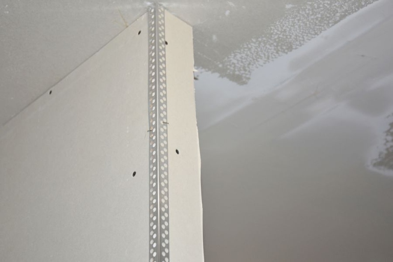 1. Remove the loose drywall by gently prying it away from the corner bead with a putty knife.