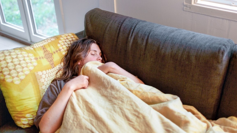 Anxiety and feeling pressured to sleep are two common reasons why people find it easier to fall asleep on the couch.