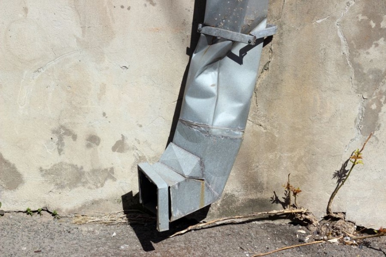 If your downspout is crushed, you have a few options for fixing it.