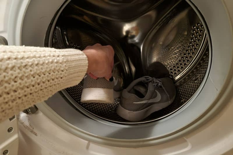 If you're looking for a way to speed up the drying process for your shoes, try attaching them to the door of your dryer.