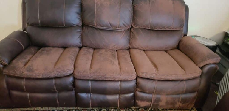 It is possible to reupholster a leather couch with fabric, but it is not recommended.