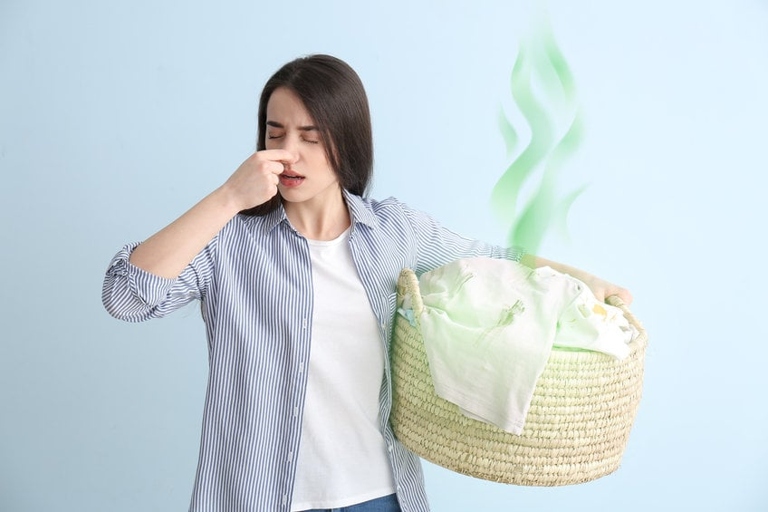 One common reason why your clothes might smell like mildew is if you're using too much bleach.