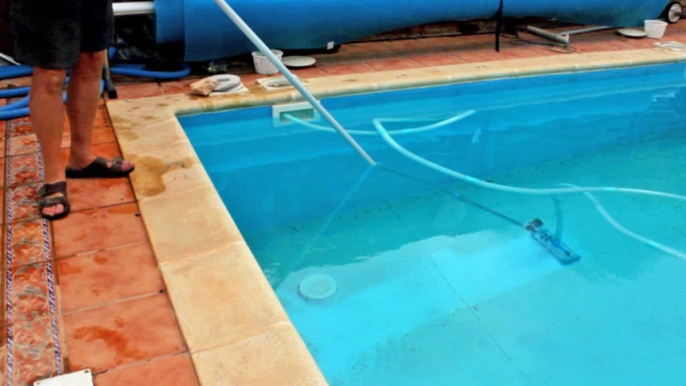 One way to remove sand from a pool is to vacuum it out with a pool vacuum.