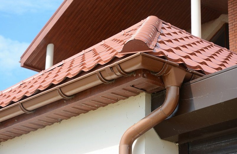 The weight of the water in the gutter can cause it to sag and pull away from the downspout, which can lead to water dripping behind the downspout and onto your home.