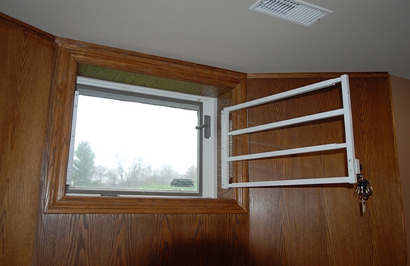 To keep your basement windows secure, either keep your curtains closed or install a window film.
