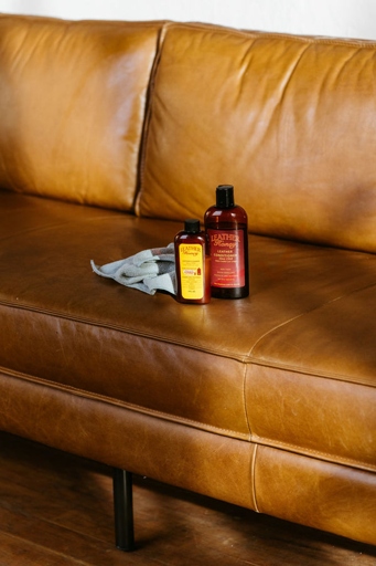 To prevent a leather couch from cracking, avoid placing it in direct sunlight and keep it moisturized with a leather conditioner.